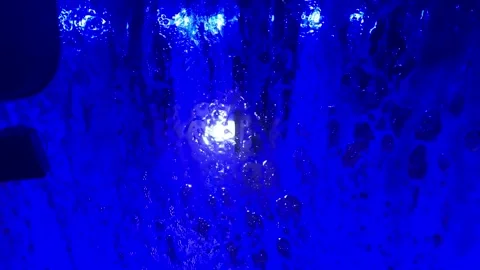 Soap suds on a windshield with dark blue lightning in a automated car wash Stock Footage 191728649