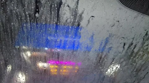 Soaping up car in drive through car wash Stock Footage 246580733