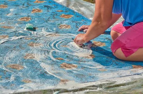 Soaping the carpet, washing the carpet on the street Stock Photos