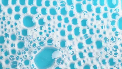 Soapsuds bubbles on blue water. Soap foam. Background of dusty foam with bu.. Stock Footage 252488963