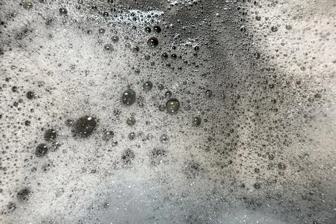 Soapy foam and bubbles create organic background plate Stock Photos