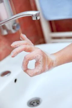 Soapy hand making circle with fingers Stock Photos
