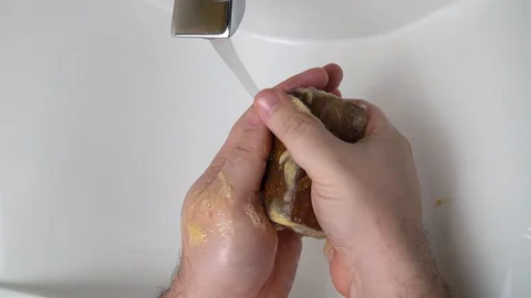 Soapy hands are holding tar soap. Hand washing. personal hygiene and health Stock Footage 127755041