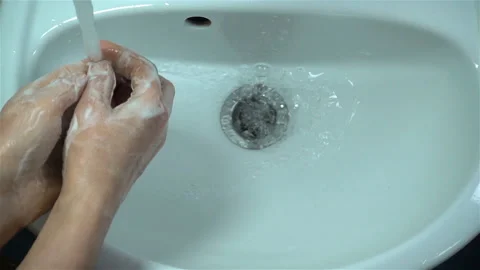 Soapy hands are washed in slow motion of water in the sink. Stock Footage 129219443