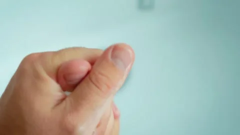 Soapy hands rubbing fingers together during thorough hand washing routine. Soap Stock Footage 345125878