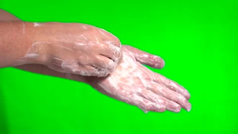 Soapy hands. Wash hands with soap on a green background. Close-up. Stock Footage 145128197
