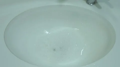 Soapy-water-draining-bathroom-sink-top-view Stock Footage 344940558