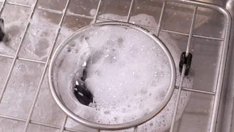 Soapy water drips down the sink drain in slow motion Stock Footage 306413129