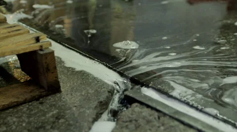 Soapy water Running into crack in concrete Stock Footage 44290272