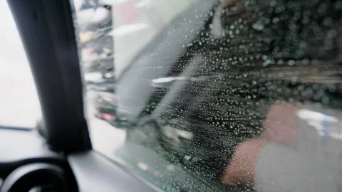 Soapy water splashing on a car window during an automatic car wash, with large Stock Footage 340230717