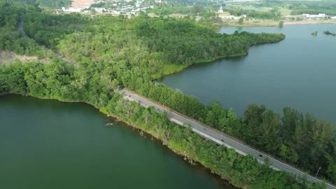 Soaring above Batam's emerald waters and lush forested terrain revealing 스톡 동영상 326188930