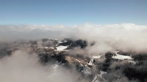 Soaring above the clouds over a scenic mountain road in western Colorado Stock Footage 123883750