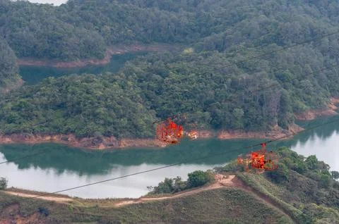 Soaring above lush landscapes and tranquil waters. A scenic cable car journ.. Stock Photos