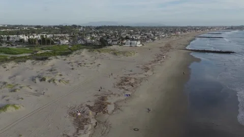 Soaring Low Over Beach Toward Homes Stock Footage 339706776