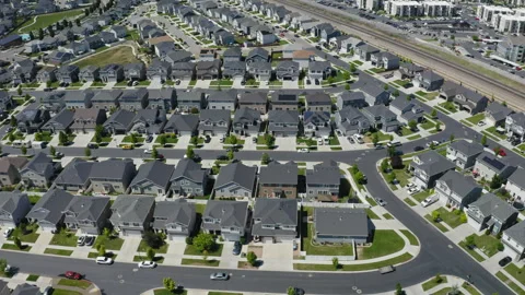 Soaring over densely packed residential neighborhood with houses close together Stock Footage 247989686