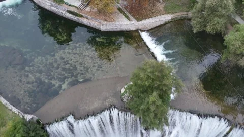 Soaring Over the Mist and Turquoise Basin of the Iconic Jajce Waterfall Stock Footage 331863521
