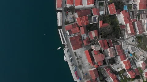 Soaring over the red rooftops of Perast, spiraling upward Video stock 166491130