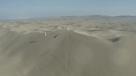 Soaring paragliders over stunning desert landscape in Iran, breathtaking aerial Stock Footage 302809265