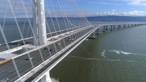 Soaring Parallel To Bay Bridge Cables And Traffic In San Francisco 스톡 동영상 121386653