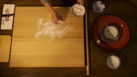Soba making, flouring the board and pressing the dough Stock Footage 223375697