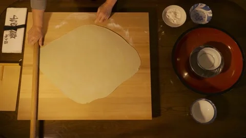 Soba making, rolling out the dough, aroung rolling pin technique to square Stock Footage 223395367