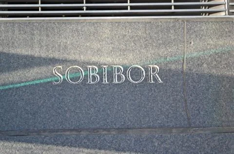 Sobibor, message closeup on stone wall. Stock Photos