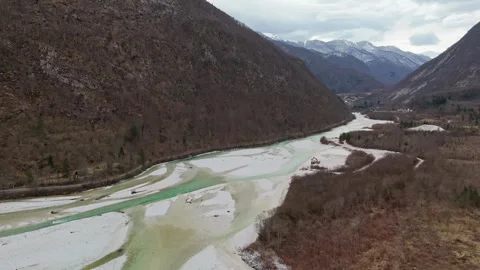 Soča River winding through snowy valley near Bovec, Slovenia aerial view Video stock 340588028