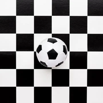 Soccer ball on chequered pattern Stock Photos