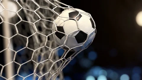 Soccer ball flies into the net on a stadium with yellow and blue lights Stock Footage