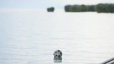 Soccer ball floating on the surface of the lake water Stock Footage 311064382