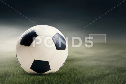 Soccer ball on the green field Stock Photos