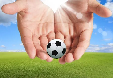 Soccer ball in hand Stock Illustration