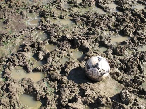 Soccer ball in the mud Stock Photos