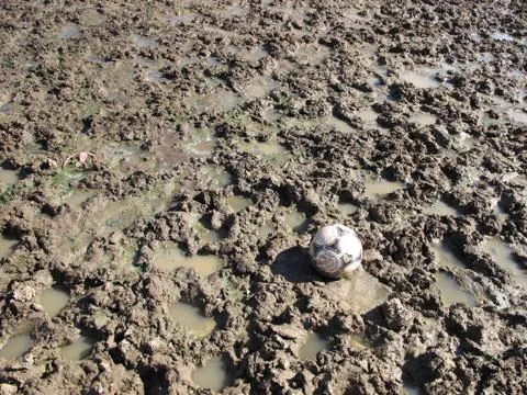 Soccer ball in the mud Stock Photos