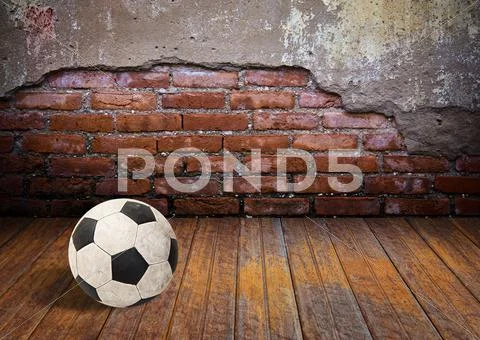 Soccer ball in the old brick room Stock Photos