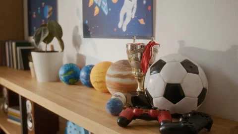 Soccer Ball, Trophy, Game Controllers, Planet Models Sitting Together Stock Footage 336173698