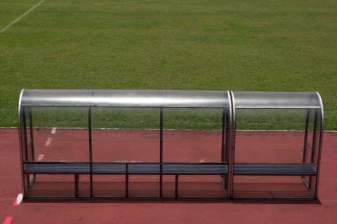 Soccer bench with empty field Stock Photos