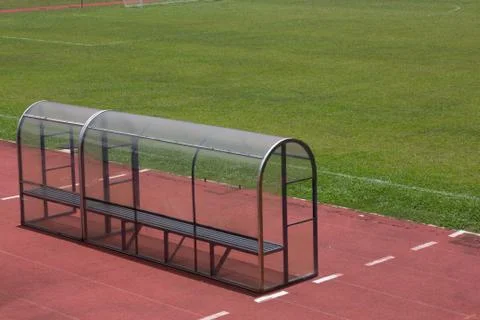 Soccer bench with empty field 스톡 사진