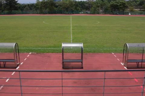 Soccer bench with empty field Stock Photos