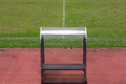 Soccer bench with empty field Stock Photos
