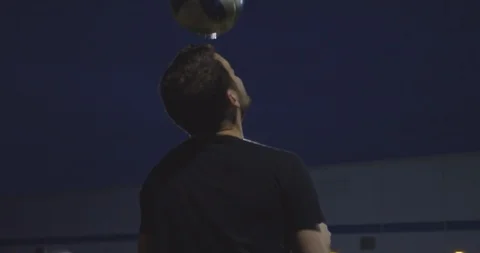 Soccer Coach At Night Practices Heading A Ball Stock Footage 94387727
