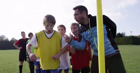 Soccer coach psyching up a young player during training session.Shot on RED Epic Stock Footage 56835688