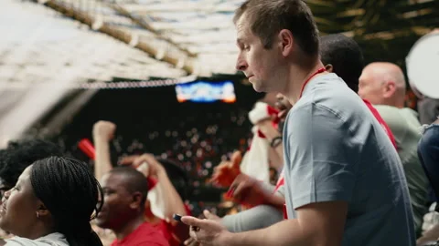 Soccer fan using betting app at the stadium during dramatic football match Stock Footage 335680001