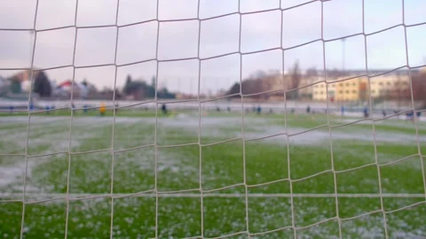 A soccer field is completely covered in a thick layer of snow, showcasing sparse Stock Footage 295931363