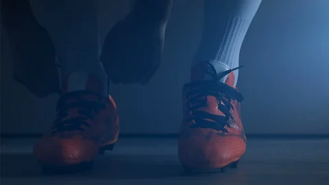 Soccer football player put on his shoes. Slow Motion. Stock Footage