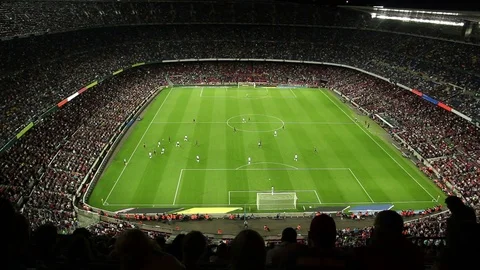 Soccer / Football Stadium at night with a match going on. Fans & Supporters Stock Footage