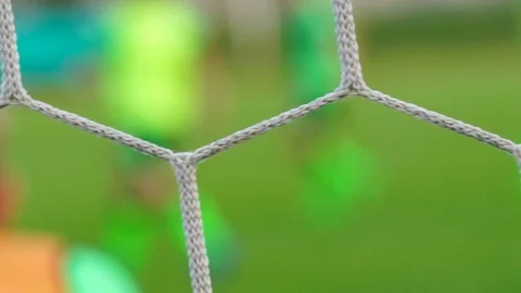 Soccer game seen through net, blurred view Stock-Footage 75776866