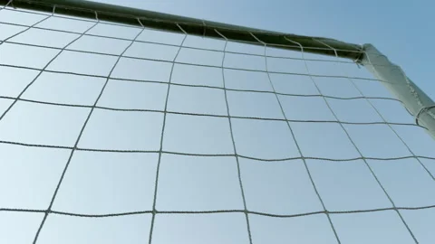 Soccer goal post and net frame a clear blue sky Stock Footage 336935621
