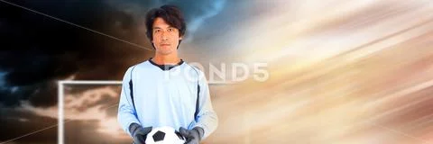 Soccer goalkeeper holding football in goal with transition Stock Photos