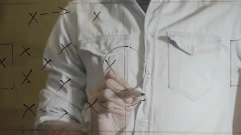 Soccer manager drawing game strategy plan on glass Stock Footage 223347916